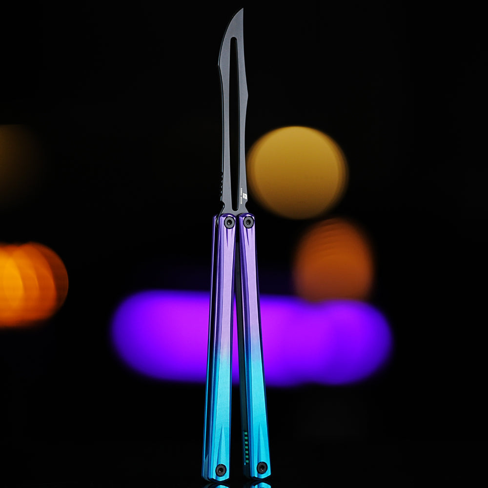 Front view of Armed Shark Eureka Balisong Trainer in purple-blue gradient anodized handle with polished stainless training edge, showcased under warm yellow and violet lighting for a sleek modern look
