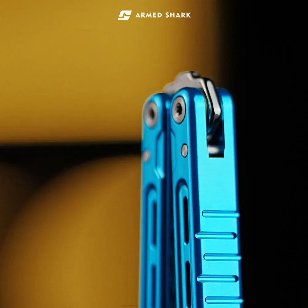 Armed Shark Athena Balisong Trainer in anodized blue, close-up view of tail structure showing T10 pivot screws and chamfered edges