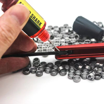 Applying Armed Shark balisong lubricant oil to pivot with nozzle