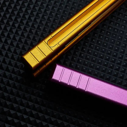 Armed Shark Balisong Trainer detailed view of gold and pink aluminum handles.