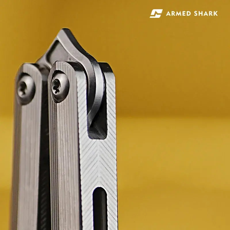 Macro close-up of Armed Shark CK-SR pivot system with chamfered titanium machining