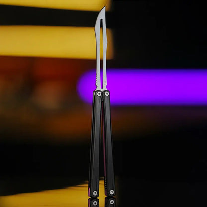 Front view of Armed Shark Eureka Balisong Trainer in matte black finish with polished stainless training edge, showcased under warm and purple studio lighting for a premium look