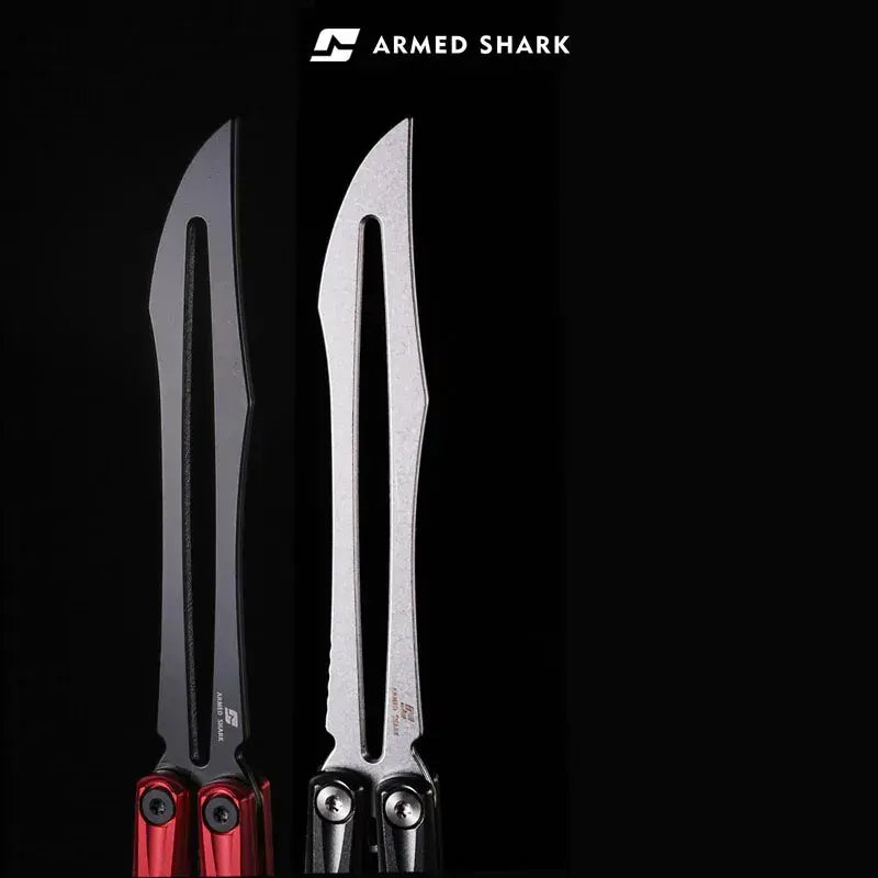 Close-up comparison of Armed Shark Eureka Balisong Trainer in red-black and silver finishes, highlighting the long slotted training edges and precision CNC-machined aluminum handles under soft studio lighting