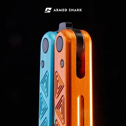 Close-up of Armed Shark Original Balisong Trainer with anodized blue and orange handles.