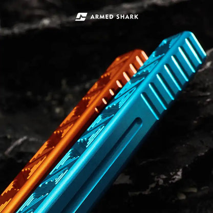 Textured blue and orange handles of Armed Shark Original Balisong Trainer shown on dark stone background.
