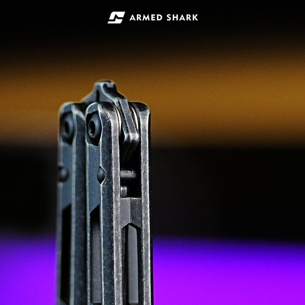 Armed Shark Prism Balisong Trainer pivot system close-up showing precision hardware and smooth rotation