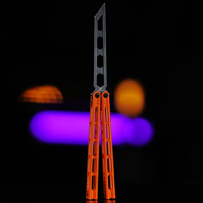 Armed Shark Prism Balisong Trainer skeleton blade version in orange handles showing lightweight structure and precision machining