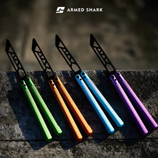 Armed Shark Sahara Butterfly Trainer lineup in green, orange, blue, and purple aluminum handles with black training edge