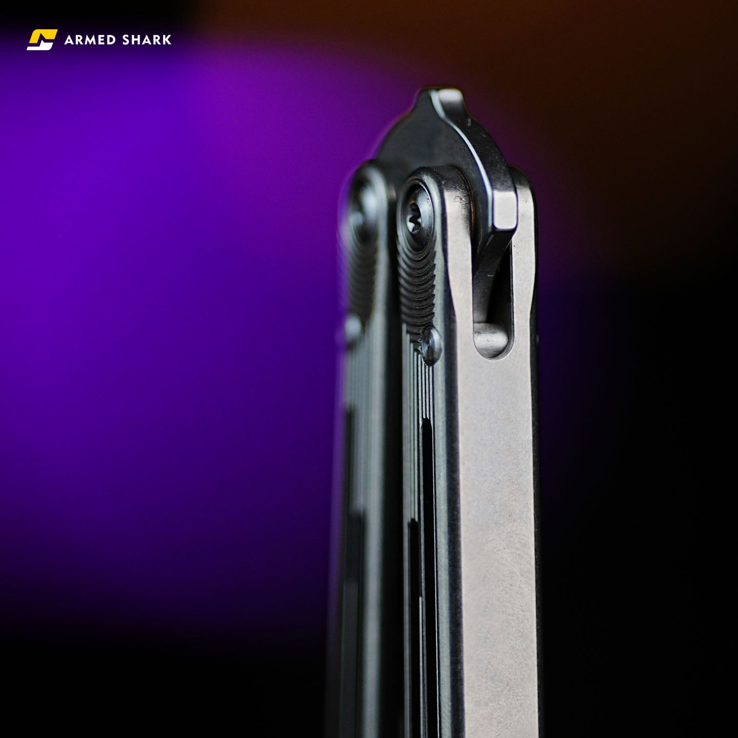 Handle close-up of Armed Shark Titanium REP balisong trainer showing pivot and screws